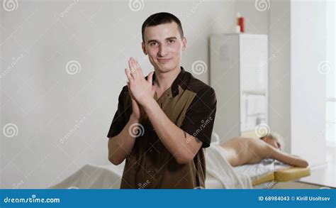 Body Care Portrait Of Masseur Standing By Massage Table In Spa Salon