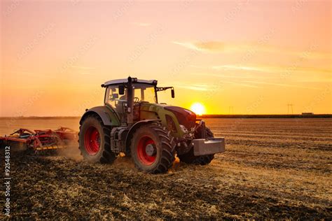 Tractor On The Barley Field By Sunset Adobe Stock