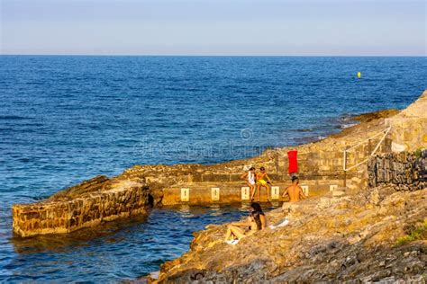 Rocky Shoreline With People Sunbathing Near Plage Paloma Beach In Saint