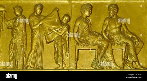 Gilded 19th century replica of the Parthenon frieze. Depicting a man and a boy with a robe held ...