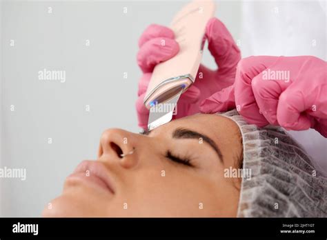 Cosmetologist Beautician In Pink Gloves Making Facial Treatment With