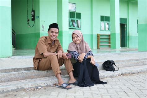 A Man in Kufi Hat and Woman in Hijab Sitting Together · Free Stock Photo