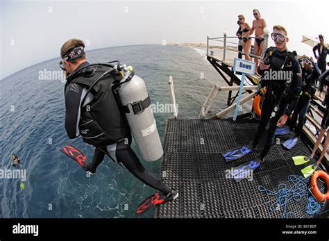 scuba diver jumping  water  jetty stock photo alamy