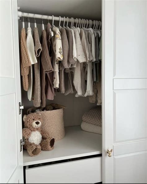 An Open Closet With Clothes And A Teddy Bear