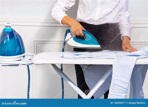 Woman S Hand Holding Steam Iron And Ironing Shirt Stock Image Image