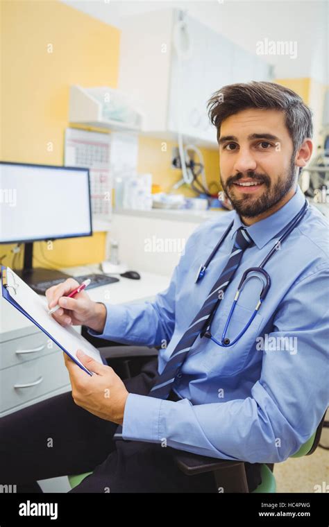 Portrait Of Doctor Writing On A Clipboard Stock Photo Alamy