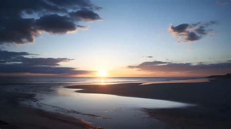 Premium AI Image | A sunset over a beach with a blue sky and clouds