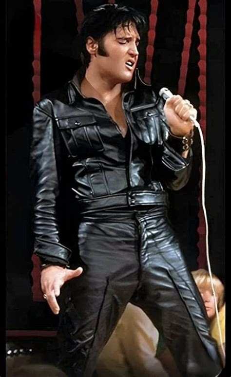 Elvis Presley Singing Into A Microphone In His Black Leather Suit And