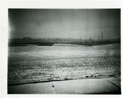 Snowy meadow and distant cityscape near Berlin, Germany in the winter