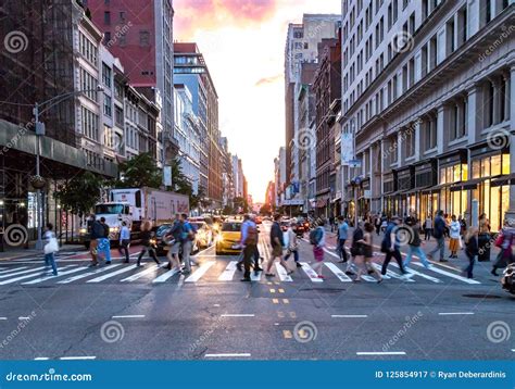 Crowds Of Diverse People Cross The Busy Intersection On 23rd Street And