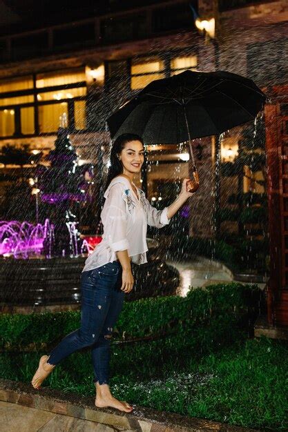 Premium Photo Cheerful Pretty Girl Holding Umbrella While Strolling