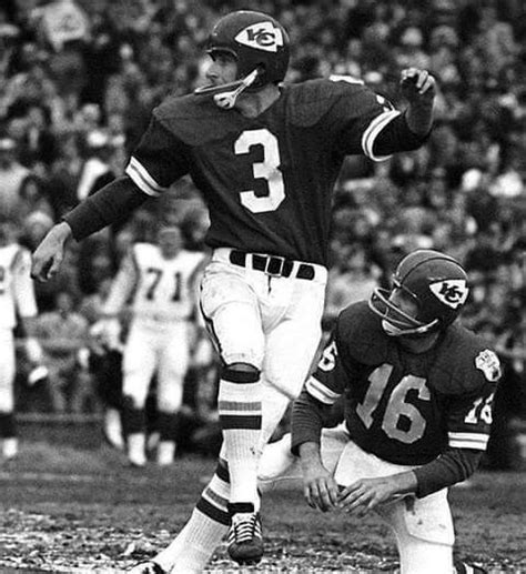 Two Football Players Are On The Field During A Game One Is Throwing