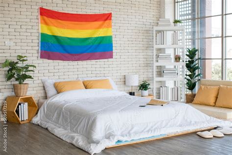 Large Rainbow Colorful Gay Pride Flag Hanging On Brick Wall Pattern