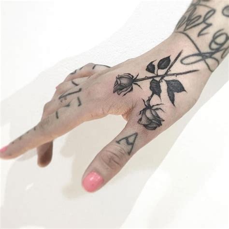 a person's hand with tattoos on it and the word love written in cursive ...