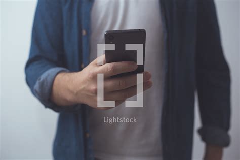 A Man Scrolling Through His Cellphone — Photo — Lightstock