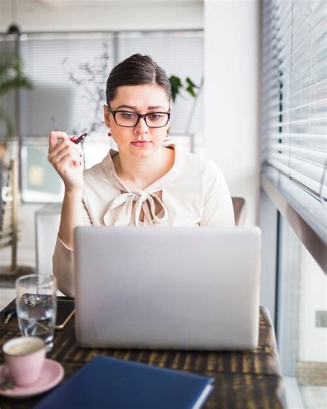 Free Photo | Young businesswoman working on laptop in coffee shop