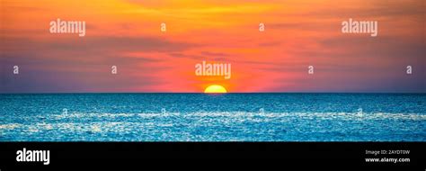 Beautiful sunset over blue sea Stock Photo - Alamy