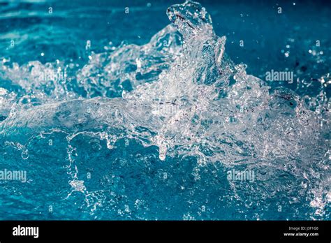 Splash of water in swimming pool with blue floor. Background image ...