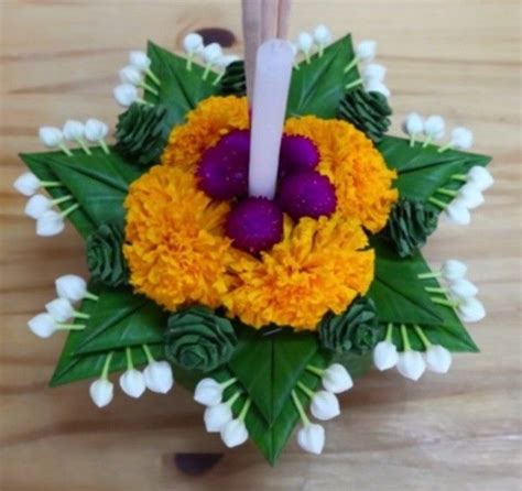 An Arrangement Of Flowers And Candles On A Table