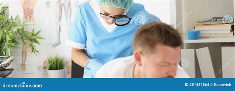 Dermatologist Doctor Examines Mole On Patients Body With Magnifying