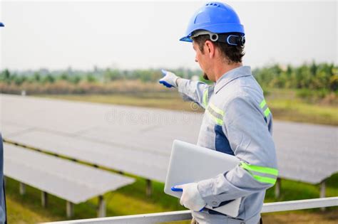 Maintenance Technician Working On Ecological Solar Cell Farm Stock