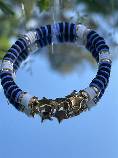 This Is A Blue Black Gold And White Clay Bead Bracelet With 3 Star