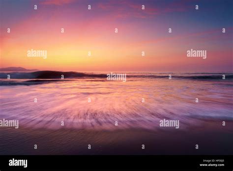 sunset on beach shore Stock Photo - Alamy