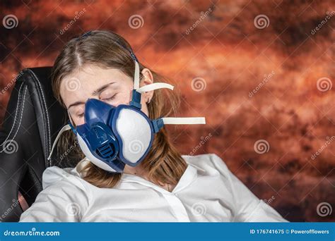 Woman In A Gas Mask Sleeping On A Chair Coronovirus Quarantine Stay