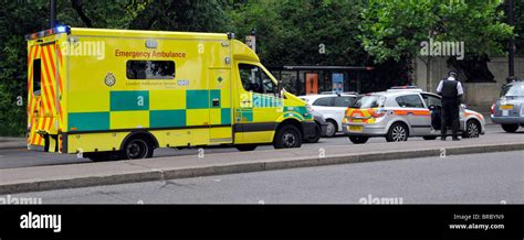 Ambulance And Police Car Attending Road Traffic Accident Stock Photo