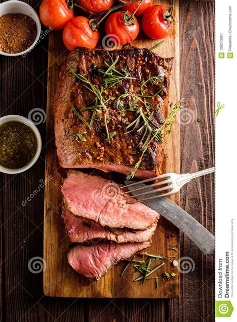 Sliced Roast Beef On Cutting Board With Grilled Vegetables Top Stock