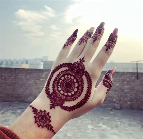 A Woman S Hand With Henna Tattoos On It