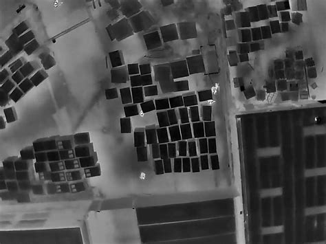 Police Drone Footage Shows Suspect Hiding In Pallet Yard Following