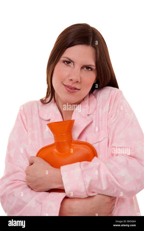 Woman Wearing Pyjamas Cuddling A Hot Water Bottle For Comfort To Keep Warm Stock Photo Alamy