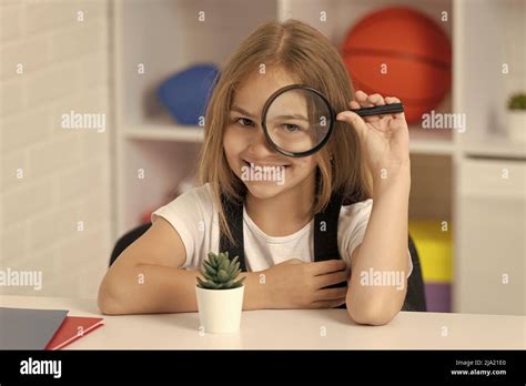 Investigate With Loupe Science And Childhood Teen Girl Looking At