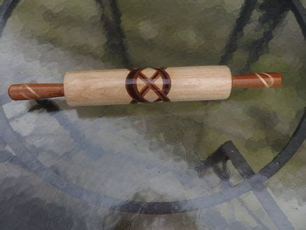 A Wooden Baseball Bat Sitting On Top Of A Glass Table Next To A Metal Clock