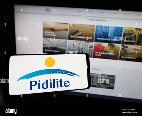 Person Holding Cellphone With Logo Of Indian Company Pidilite