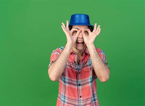 Emocionado apuesto hombre caucásico vestido con gorro de fiesta azul