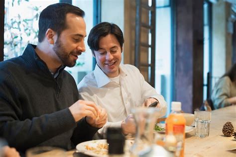 Premium Photo Men Sharing Text At Restaurant Table