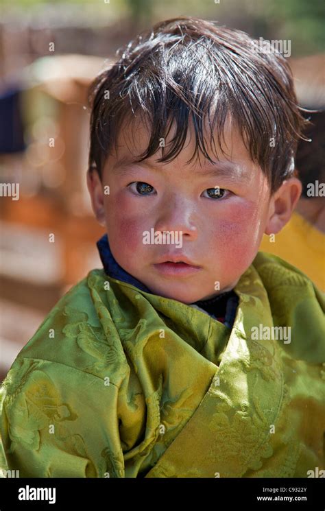 A Young Bhutanese Boy Wearing The Traditional Male Attire Called Gho