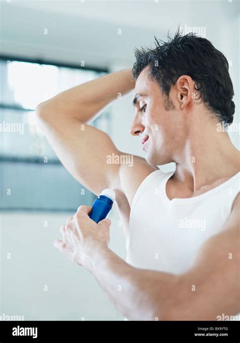 Man Putting On Deodorant