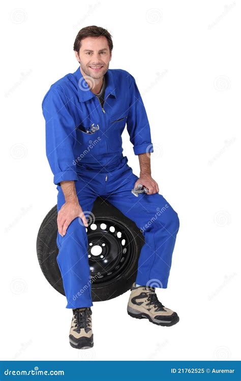 Mechanic Sitting On A Tyre Stock Image Image Of Spanner 21762525