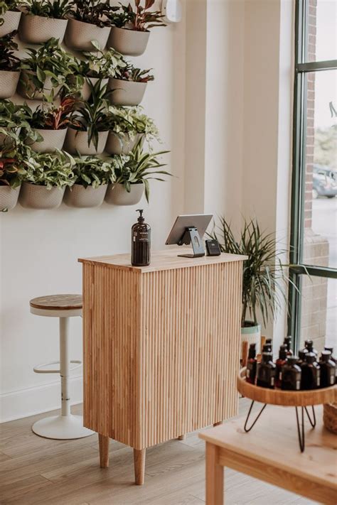 Cute Modern Boho Earthy Salon Decor Idea With A Plant Wall And A Clean