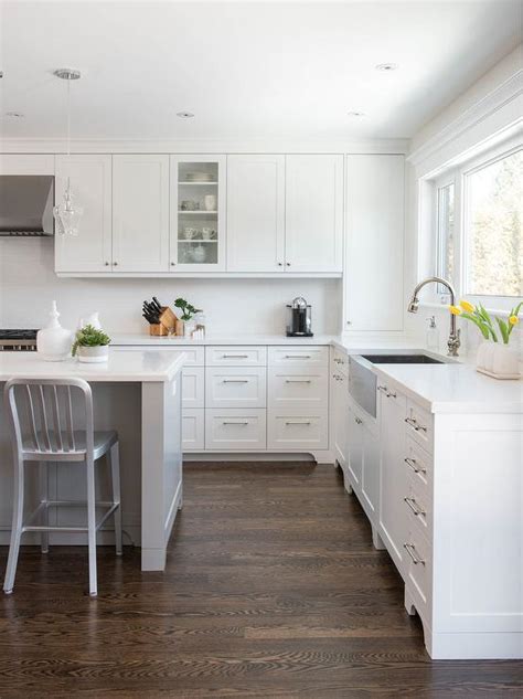 Gray Center Island With Coffee Stained Oak Wood Floors Transitional