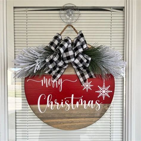 A Merry Christmas Sign Hanging On The Front Door