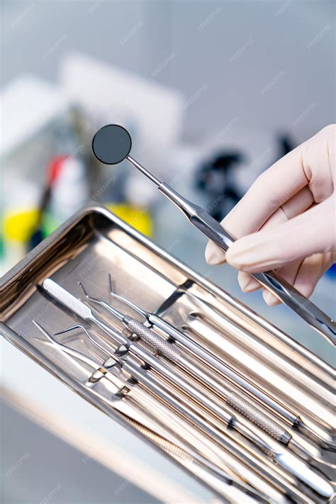 Premium Photo | Stainless stomatology devices in hands Dental medical