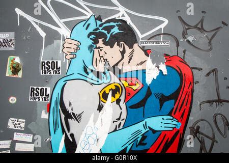 Batman kissing superman Stock Photo - Alamy