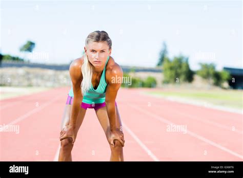 Tired Female Athlete Standing On Running Track Stock Photo Alamy