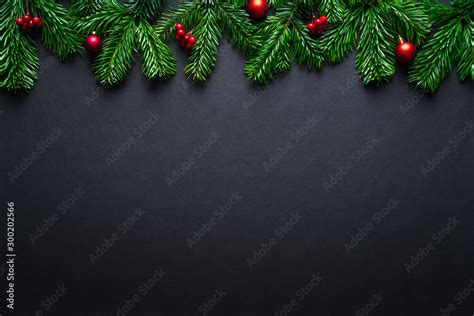 Black Christmas border with fir branches and baubles Stock Photo ...