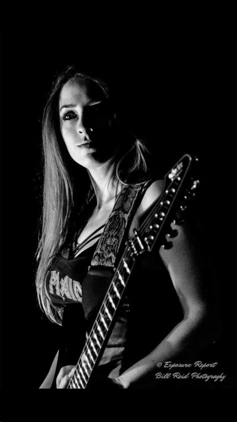 A Woman With Long Hair Holding A Guitar