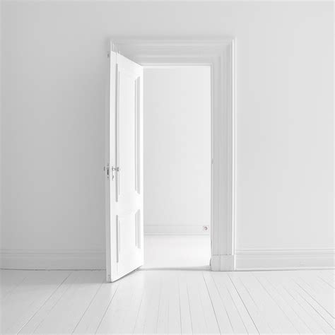 A White Door Opened To A White Room With A White Door Open To The Left